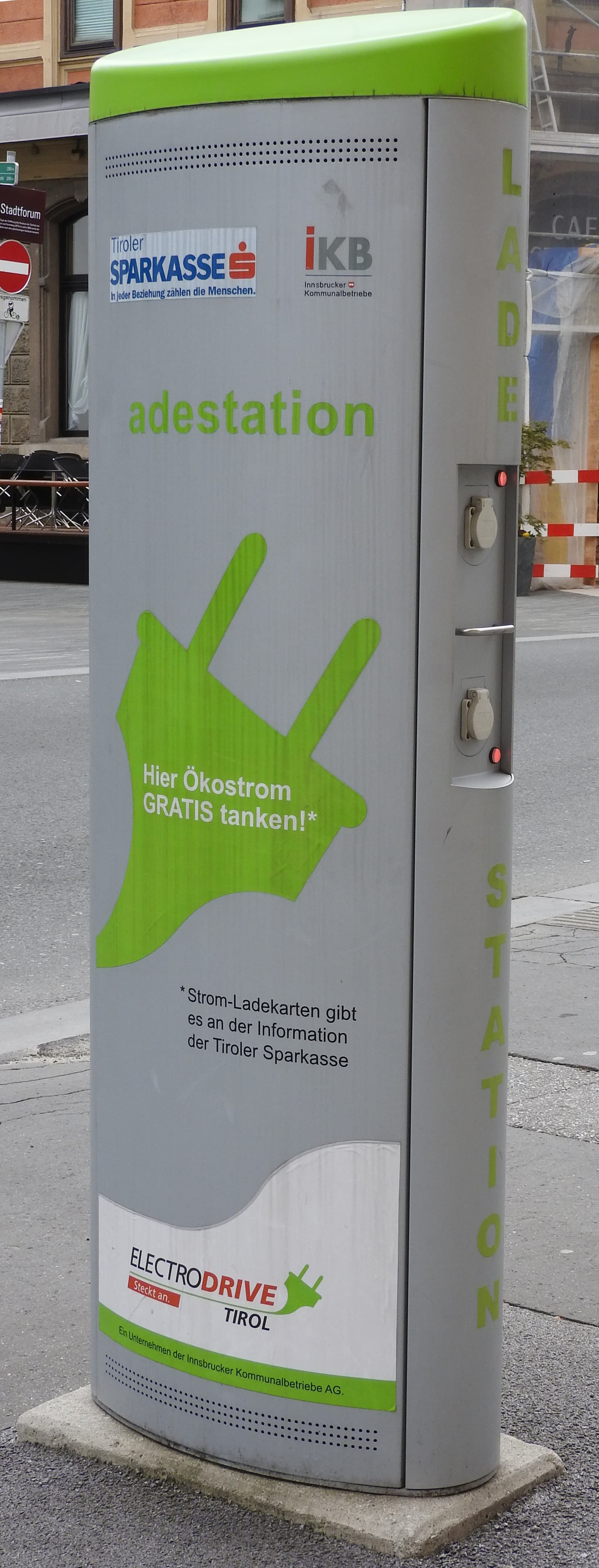 Electric vehicle charging station with EV plugged in and charging